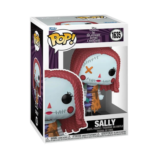 A cardboard box with a transparent front, containing a Funko Pop! figure depicting Sally from The Nightmare Before Christmas. Sally's clothes are stitched together from mismatched pieces of fabric.
