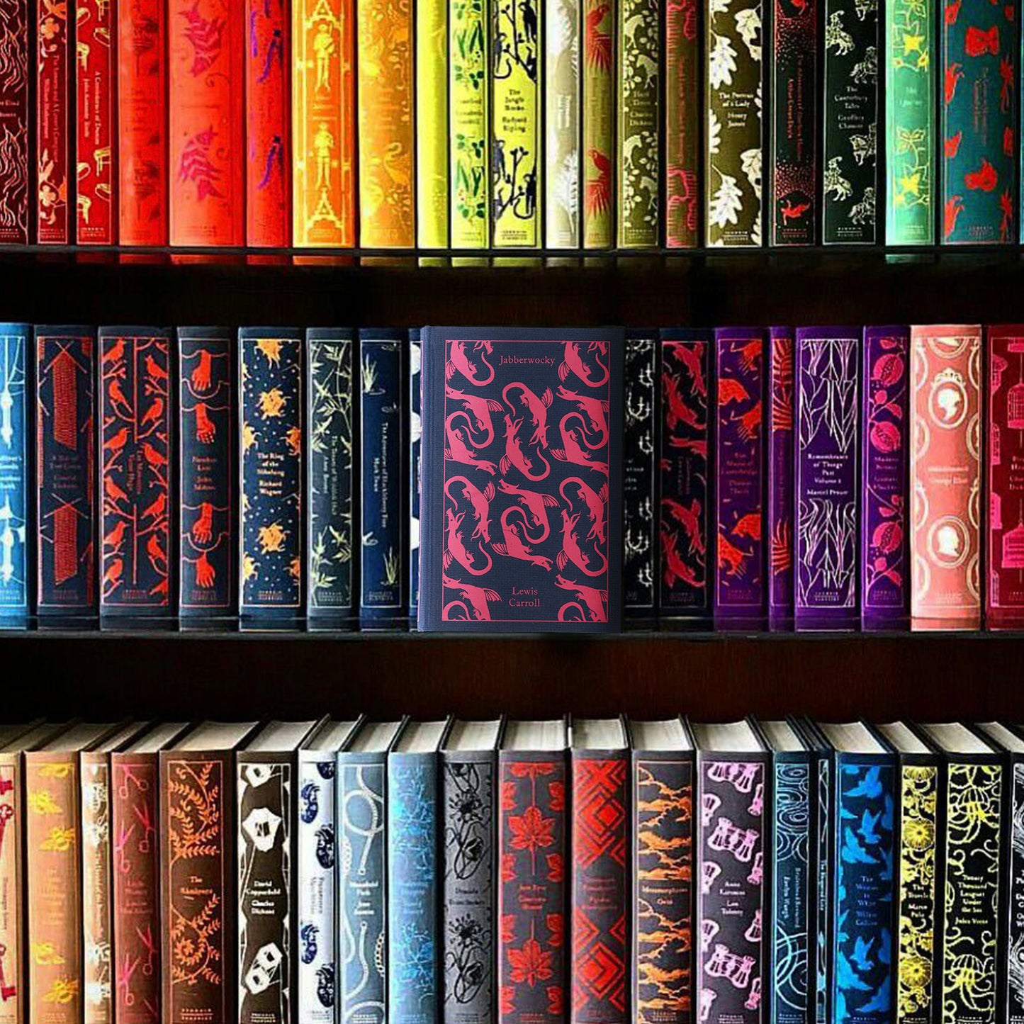 A bookshelf with three shelves on which a number of colorful, hardcover clothbound books sit in neat rows.
