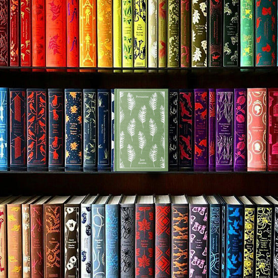 A bookshelf with three shelves on which a number of colorful, hardcover clothbound books sit in neat rows.