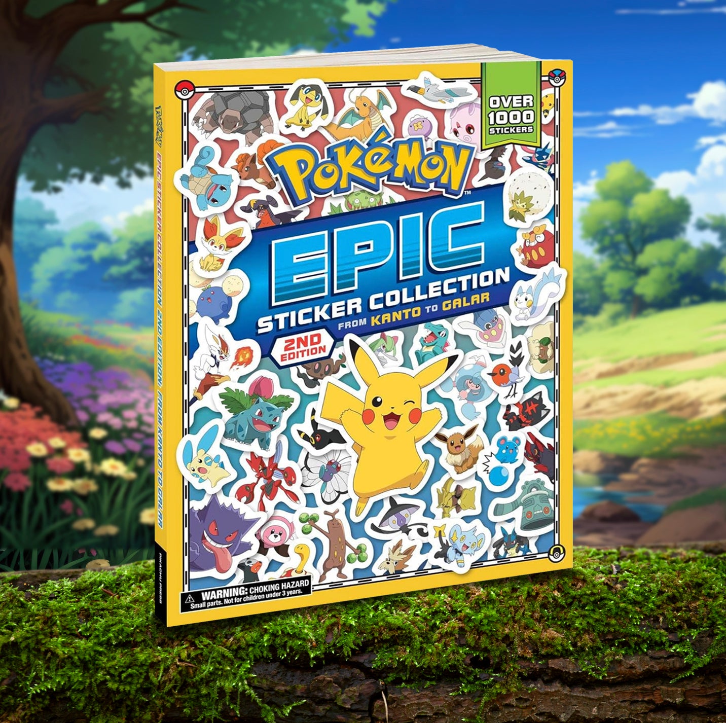 A yellow softcover book on a moss-covered log. On the cover is a collage of stickers depicting various Pokemon characters. Yellow and blue text says "Pokemon epic sticker collection." In the background is a colorful drawing of a meadow, with trees and flowers in the distance.