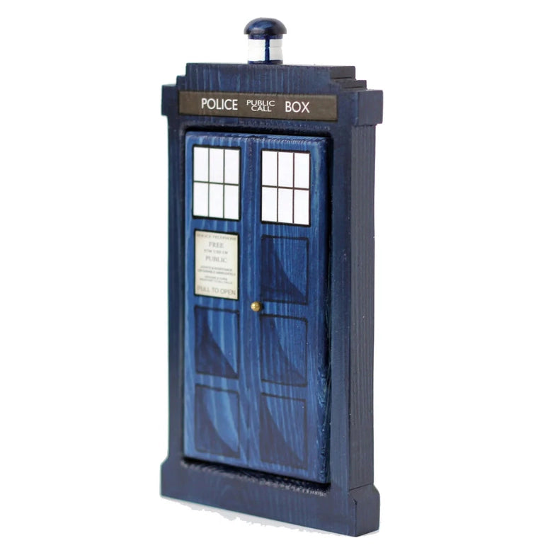 Load image into Gallery viewer, A side view of a rectangular wooden doorframe with a blue door, against a white background. The door features the design of the TARDIS, including the POLICE BOX design, windows, and top light. 
