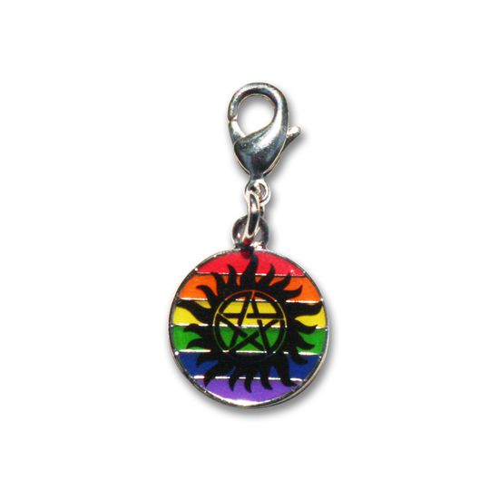 Load image into Gallery viewer, A brass charm with rainbow stripes, and the anti-possession symbol in black, against a white background.
