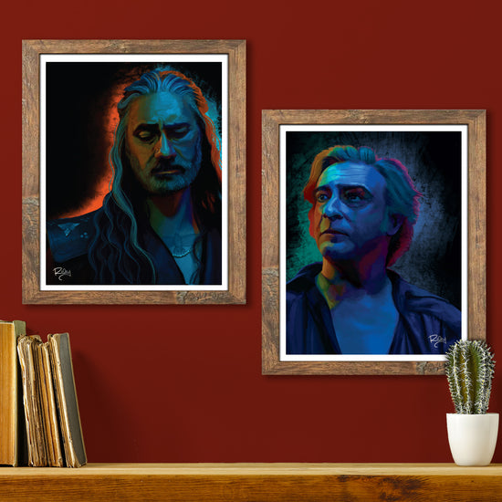Two framed lithographs on a red wall. One lithograph depicts the character Stede from Our Flag Means Death. The other depicts the character Ed.