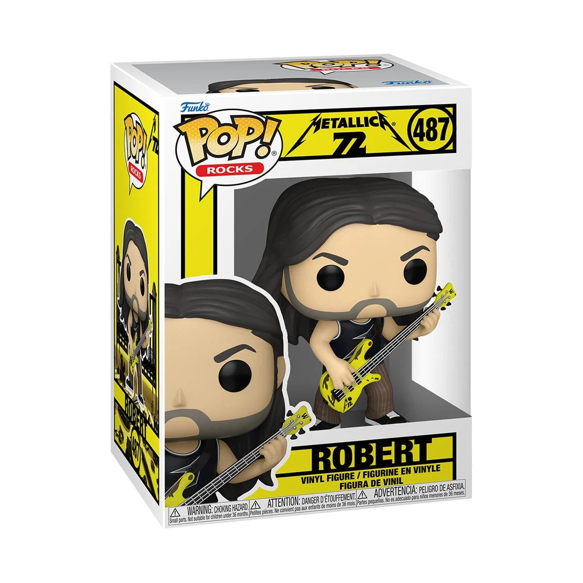 A cardboard box with a transparent front, containing a bobblehead figure depicting Robert Trujillo from the band Metallica. Robert is holding a yellow bass guitar, and is wearing a pair of brown striped pants.