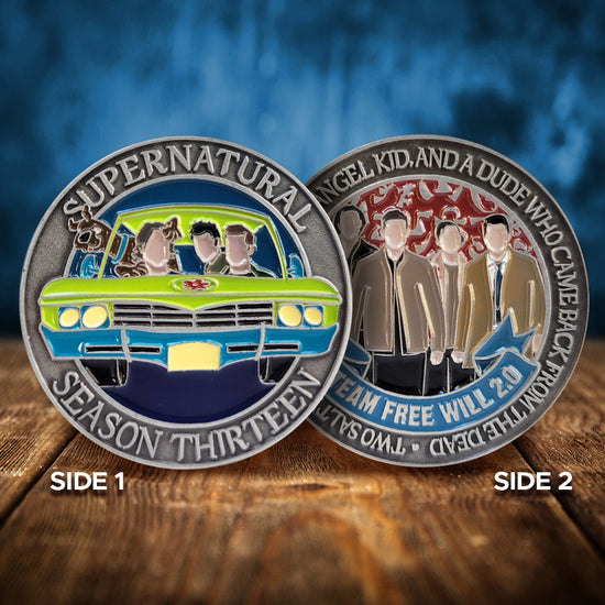Front and back images of a brass coin, against a blue background. The front depicts SPN characters in a green and blue car, with a dog out the window. Raised text around the edge says "supernatural season thirteen." The back depicts characters wearing brown jackets. Raised text says “Two salty hunters, one half-angel kid, and a dude who just came back from the dead. Team Free Will 2.0"