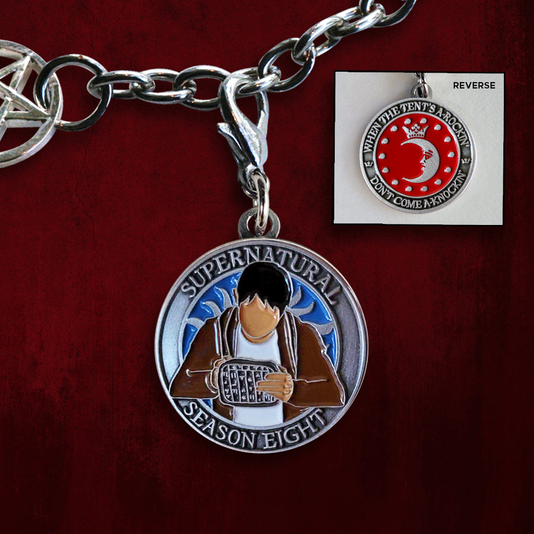 A brass coin with "Supernatural season eight", a blue background, and a sillhouette of Kevin Tran with a tablet on one side, and "When the tent's a-rockin', don't come a-knockin'.", and a silver moon and circle of small silver dots against a red background on the other