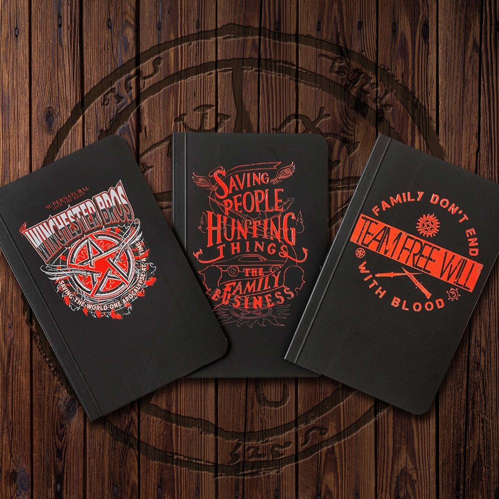 A layout of 3 small black notebooks, all with red (and white) designs. The first says "Winchester Bros" above a pentagram, and "Saving the world one apocalypse at a time" below it. #2 reads "Saving people, hunting things, the family business" with line art motifs of angel wings, a Chevy Impala, and silhouettes of the Winchester brother's profiles. #3 reads "Familg don't end with blood: Team Free Will" and depicts an angel blade, demon knife, and anti-possession symbol.