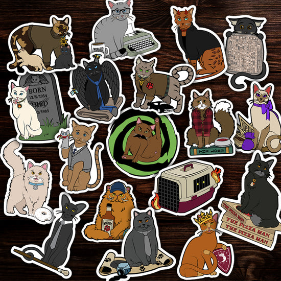 Collection of various cat-themed stickers on a wooden surface