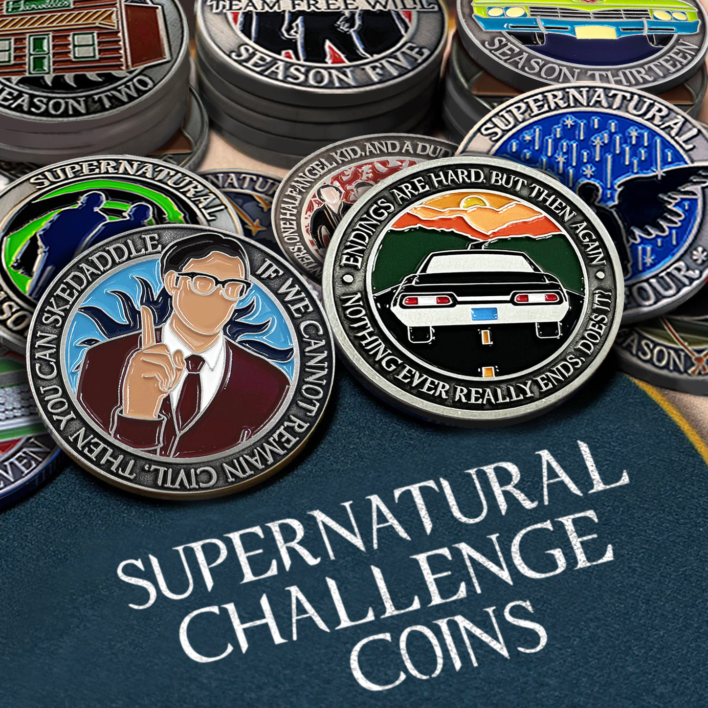 An image of stacks of Supernatural challenge coins. The back rows are neatly stacked, while the front row has coins scattered on top of each other as if tossed onto the table top. The bottom reads "Supernatural Challenge Coins" in white all-caps.