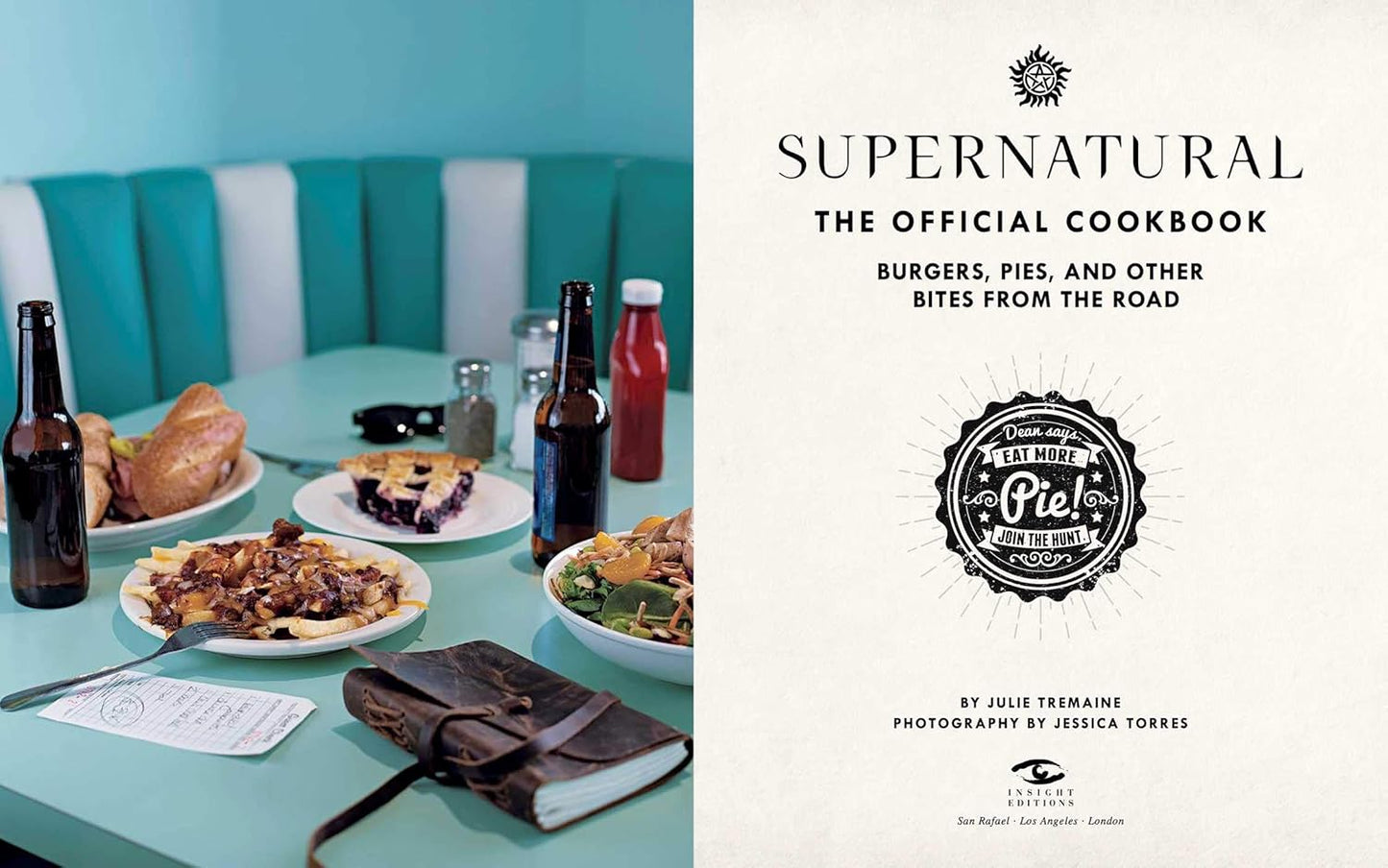A two-page spread from the book. On the left are half-eaten meals on a light blue diner table, with beer bottles and a Hunter's journal next to the plates. On the right is the title page from the book, with black text saying "supernatural, the official cookbook: burgers, pies, and other bites from the road."