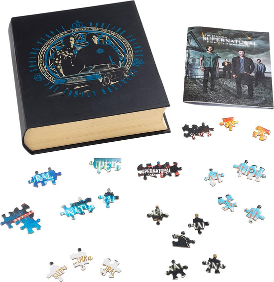 An image of a black book with drawings of Sam and Dean Winchester, surrounded by jigsaw puzzles pieces, on a white background. At the top right is a book with characters from the TV series supernatural standing next to a white house.