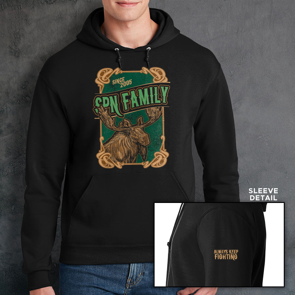 Load image into Gallery viewer, A male model wearing a black hooded sweatshirt, against a grey wall. On the front of the shirt is a green and brown rectangle with a brown frame. A brown moose is depicted at the bottom. Green text says &amp;quot;SPN Family&amp;quot; across the middle. At the top is light brown text saying &amp;quot;Since 2005.&amp;quot; At the bottom right corner is a close up of the left sleeve, with yellow text saying &amp;quot;Always Keep Fighting.&amp;quot;
