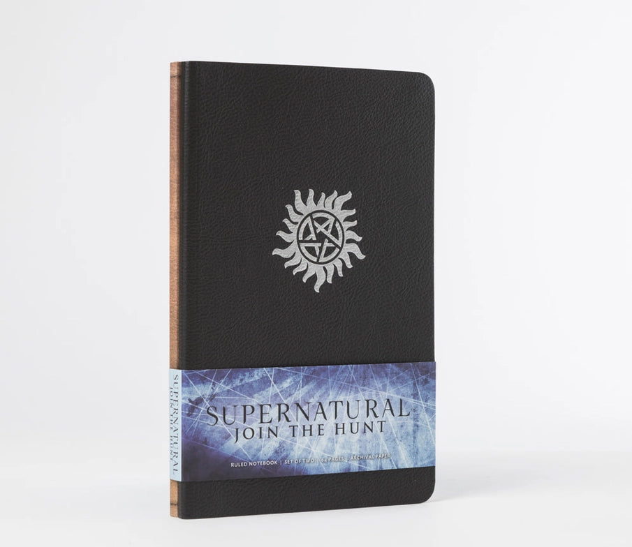 Two small journals bundled together. The front journal has a black cover, and features the Anti-Possession symbol in silver. The back journal is brown. Across the bottom is a blue and white banner with black text that says "Supernatural: join the hunt."