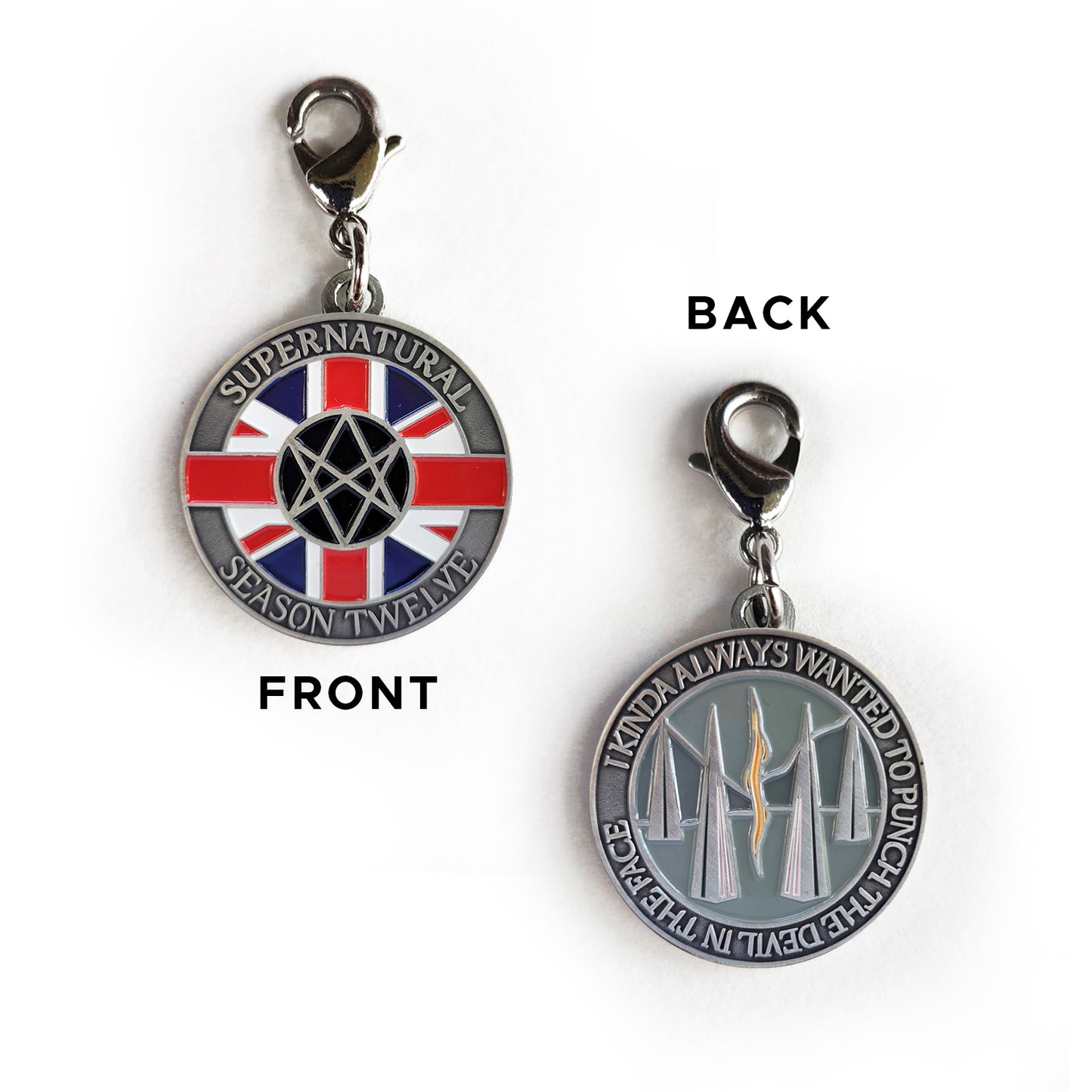 Load image into Gallery viewer, A front and back image of a brass charm. On the front are raised letters around the edge saying “Supernatural season Twelve.” In the middle is a red, white, and blue Union Jack flag, with a Men Of Letters symbol at the center. On the back of the coin are raised letters around the edge saying “I kinda always wanted to punch the devil in the face.” In the middle is are tall triangles rising from a grey background, with a read and yellow line down the center.

