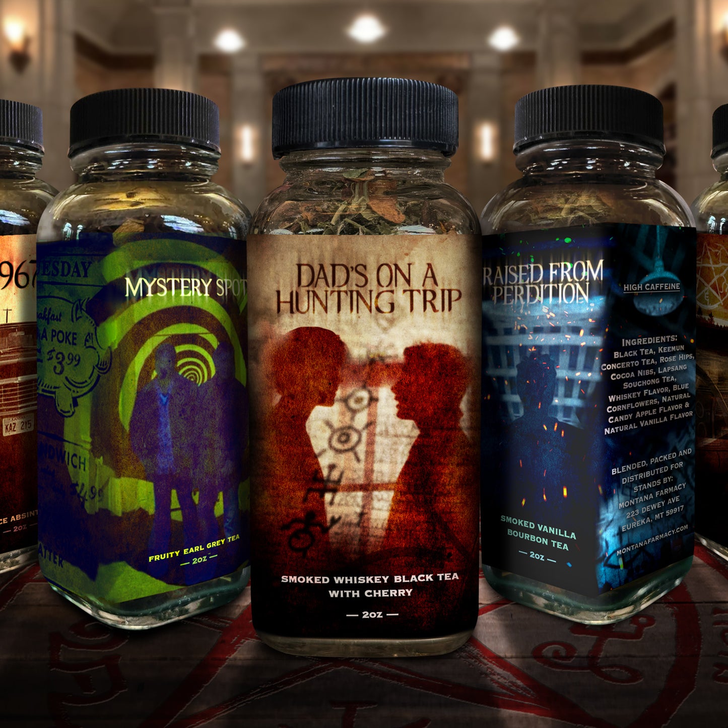 Collection of SPN-themed tea bottles with various labels on a wooden surface.