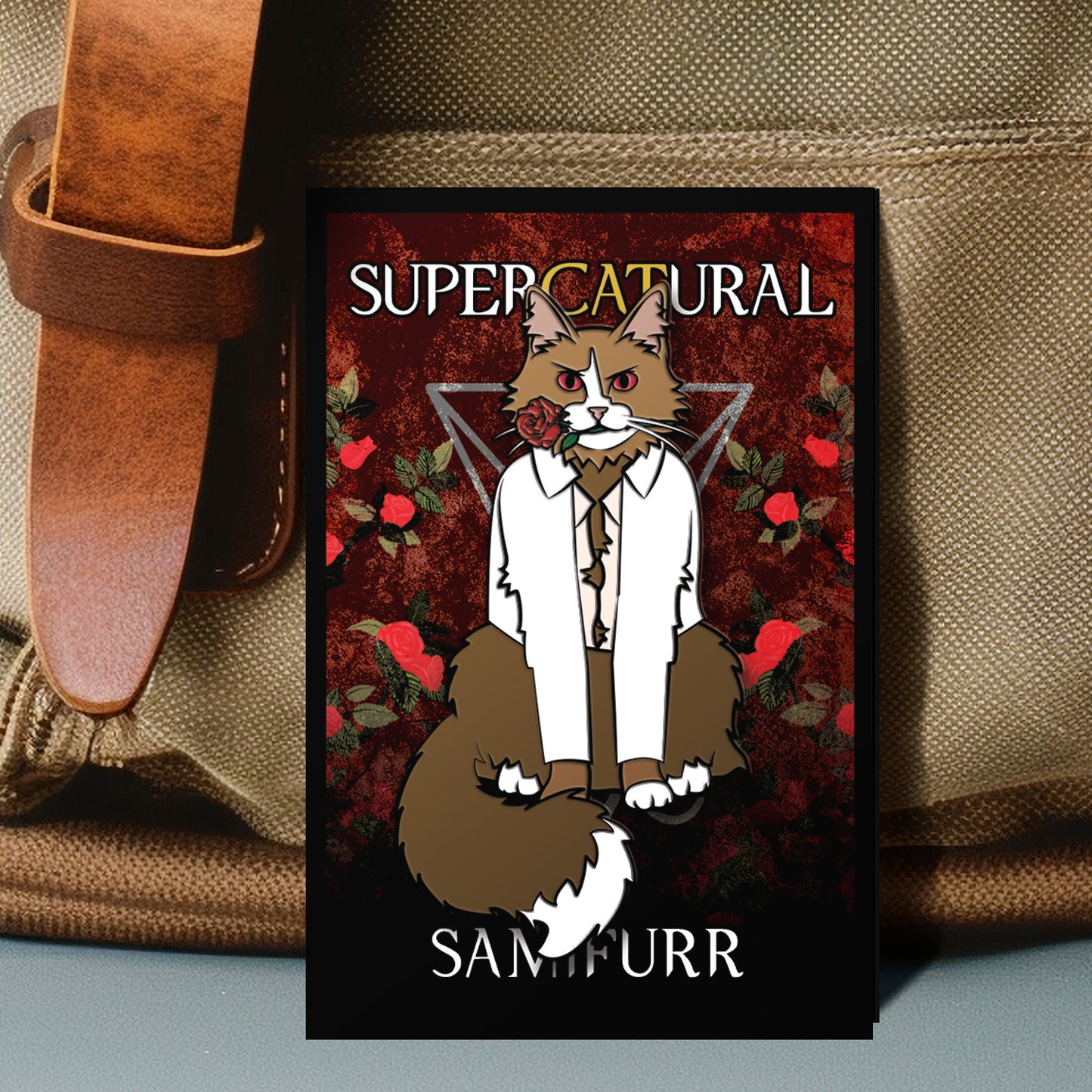 Card with a cat in a suit and tie design, labeled 'Supercatural Sam Furr', on a textured surface.
