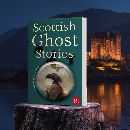 A green book on a tree stump, with a lake and Scottish castle in the background. The book's cover depicts a black raven perched on a skull, inside a glass circle. Across the cover are black raven silhouettes in flight.