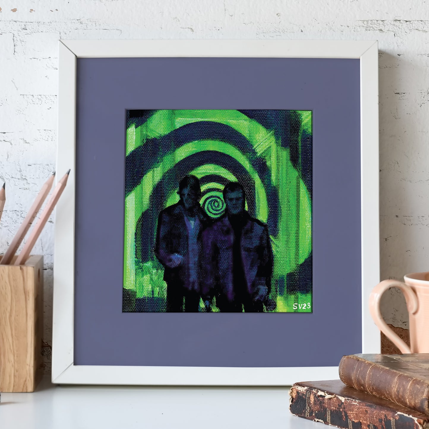 A painting mounted on a blue background in a white frame. The painting shows Sam and Dean Winchester against a green and black spiral from The Mystery Spot. Behind the painting is a white brick wall.