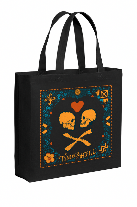 A black tote bag on a white background. The tote depicts two orange skulls facing each other, with a red heart above the,. Orange text at the bottom says "tender as hell." Around the border is a blue and orange pattern depicting horses, flowers, and fruits.