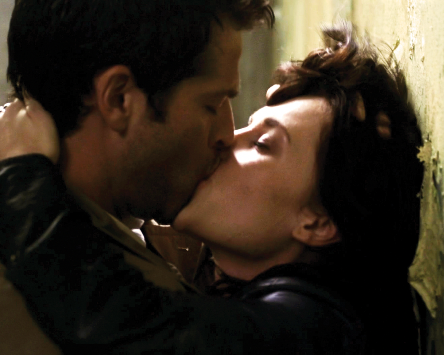 A still image from Supernatural showing Castiel and Meg kissing