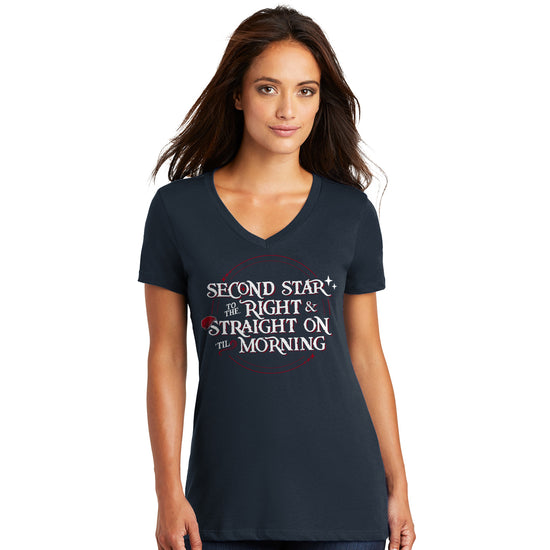 A female model against a white background, wearing a blue v-neck tee shirt. The shirt has white text saying "second star to the right & straight on til morning." A red hat hangs on the "S" in the word "Straight."