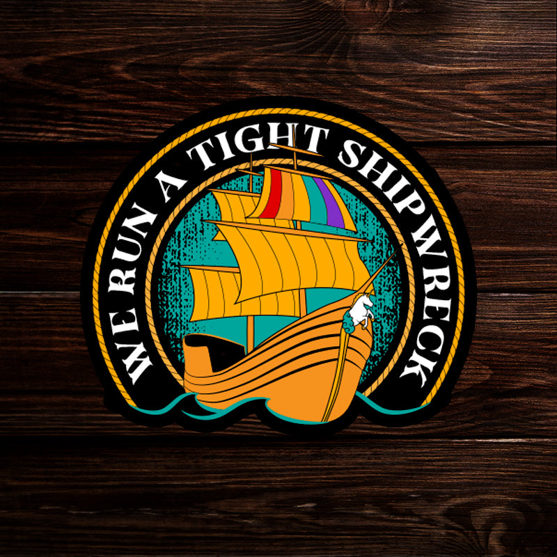 A sticker depicting a pirate ship with a rainbow sail. Text around the edge says "we run a tight shipwreck."