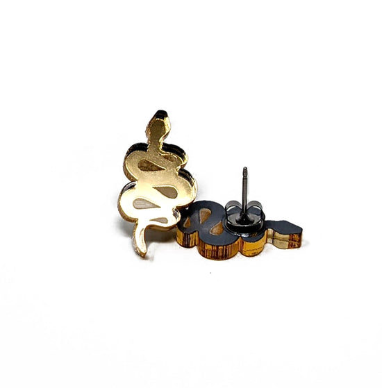 Load image into Gallery viewer, Two gold earrings in the shape of coiled snakes, against a white background.
