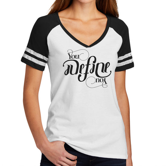 A female model wearing a black V-neck shirt with black sleeves. On the front is black text saying "You define you." The text is designed to be readable right side up or upside down.