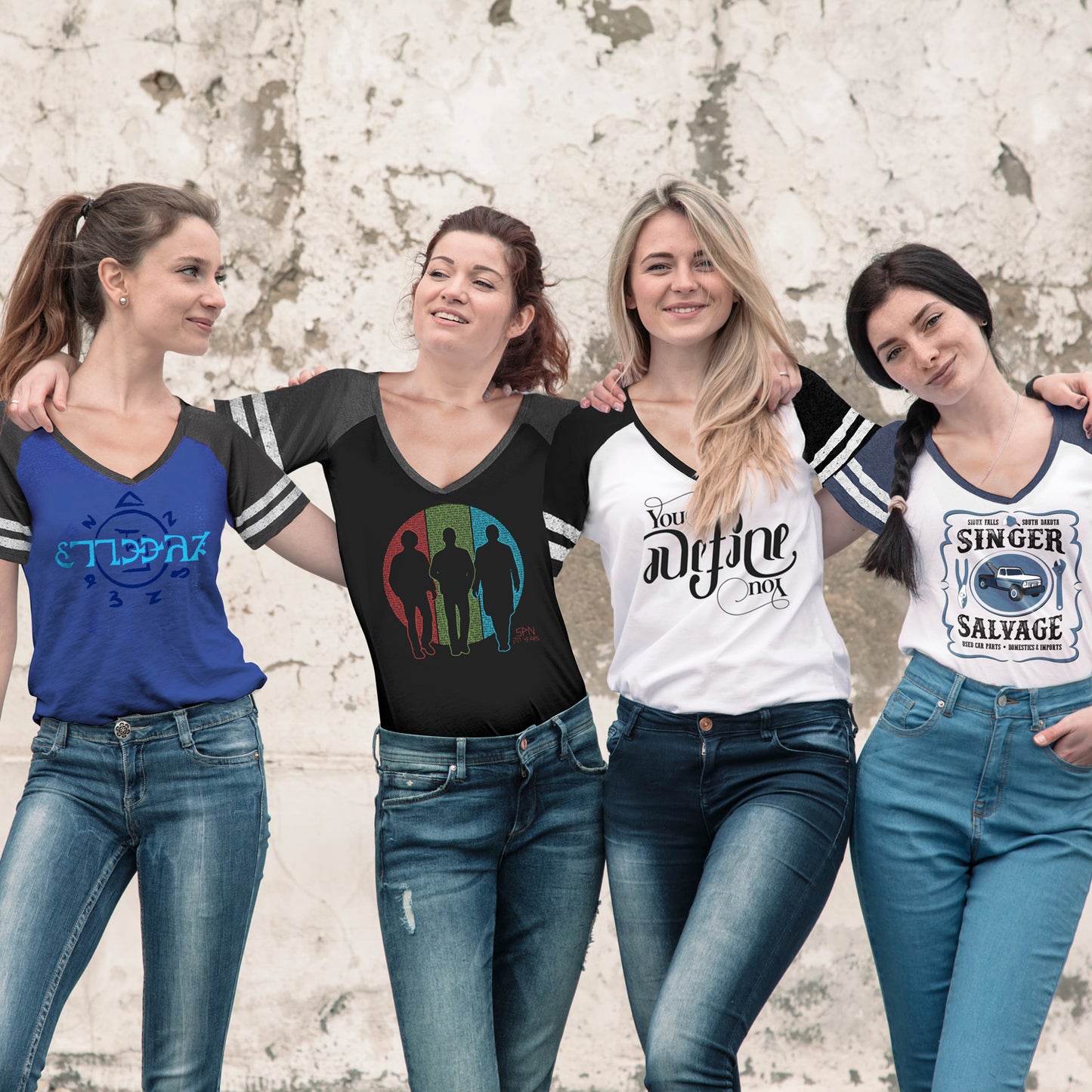 Four female models side by side, each wearing a v-neck shirt with Supernatural-themed designs on the fronts.