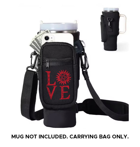 A black caddy bag designed to hold a large travel mug. The front of the bag has red text saying Love, with the "o" replaced by the anti-possession symbol. The bag has several zippered pockets, and a travel mug is inserted at the top. A black strap is attached to the bag. The front pocket has a cell phone and cash sticking out of it. Black text at the bottom says "mug not included. carrying bag only." At the top right is a smaller image of the bag, seen from the side.