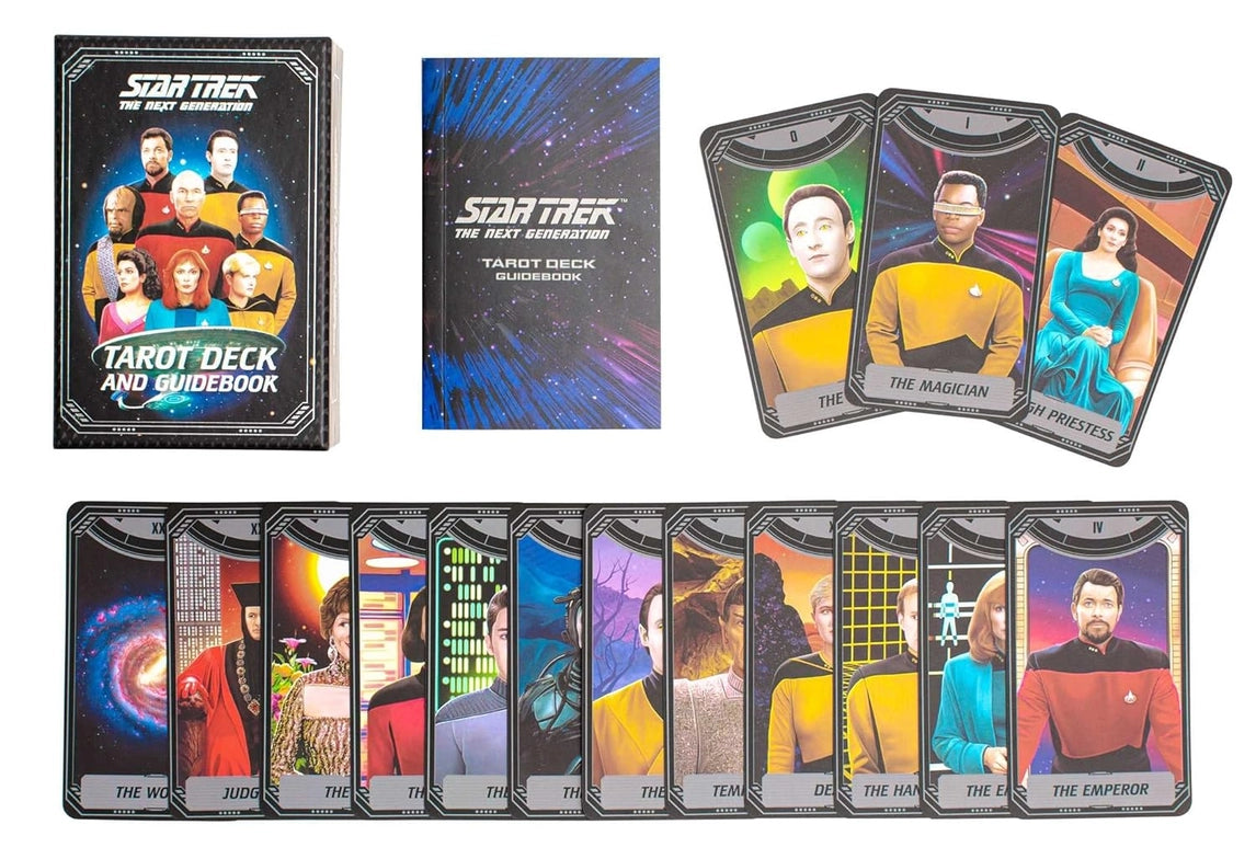 A spread of tarot cards depicting characters from Star Trek: The Next Generation on them. Each card has a tarot title at the bottom, such as "The Emperor, the magician, the priestess," and others. Among the cards is a guidebook intructing how to use the deck. The cover of the guidebook depicts deep space with a blue and purple borealis. White text says "Star Trek The Next Generation Tarot Deck and Guidebook."