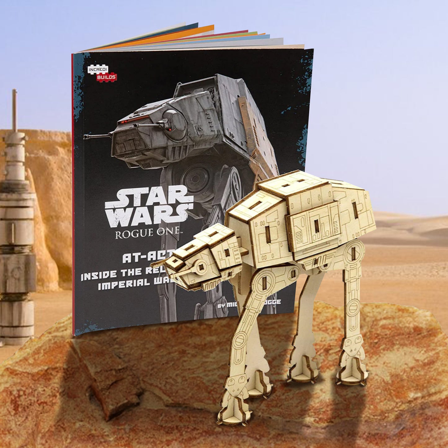 A wooden model At-At Walker from the Star Wars movies, standing on a rock in a desert. Next to it is a booklet with assembly instructions.