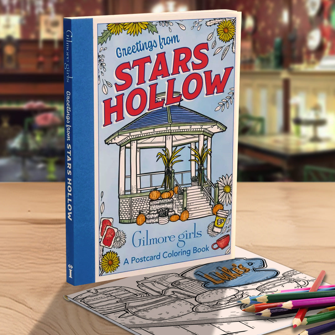 Coloring book titled 'Greetings from Stars Hollow' by Gilmore Girls with coloring paper and pencils against a Dragonfly Inn background