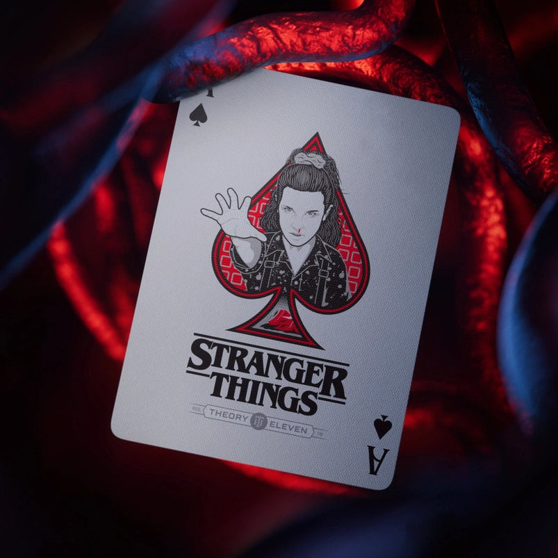 An Ace of Spades playing card. In the center is a depiction of Eleven from Stranger Things.