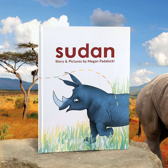 A white book standing on a flat rock, set against a Serengeti background. A drawing of a blue rhinoceros is in the middle of the cover, standing amongst grass. At the top is "sudan: story and pictures by megan padalecki" in maroon letters.