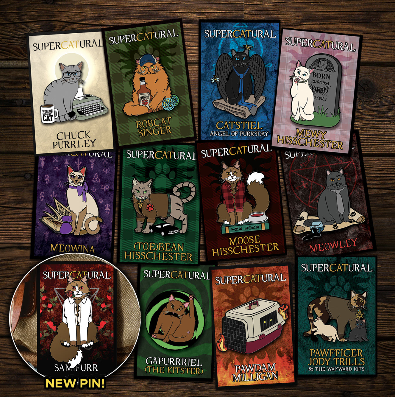 A collection of enamel pins on a wooden table. Each pin depicts a character from the TV series "Supernatural" reimagined as cats. An inset in the bottom left corner reads "NEW PIN!" and has an image of Samifurr, the newest pin.