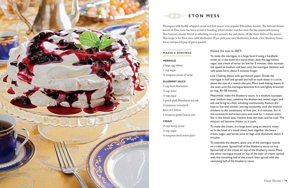 A two-page spread from the book. On the left is a meringue dessert covered in blueberry compote, on a crystal cake pedastal. Around the cake are fine china plates and teacups with blue and gold trim. On the right is a white page with a recipe for Eton Mess.