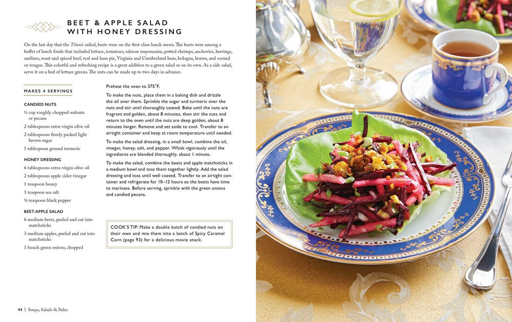 A two-page spread from the book. On the left is a recipe for beet and apple sale with honey dressing. On the right is the salad on a fine china plate with blue and gold trim, on a gold tablecloth. Around the plate is a formal place setting.
