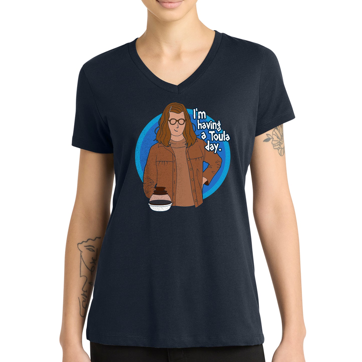 Person wearing a dark blue t-shirt with a graphic and text 'I'm having a Toula day.' in front of a white background.
