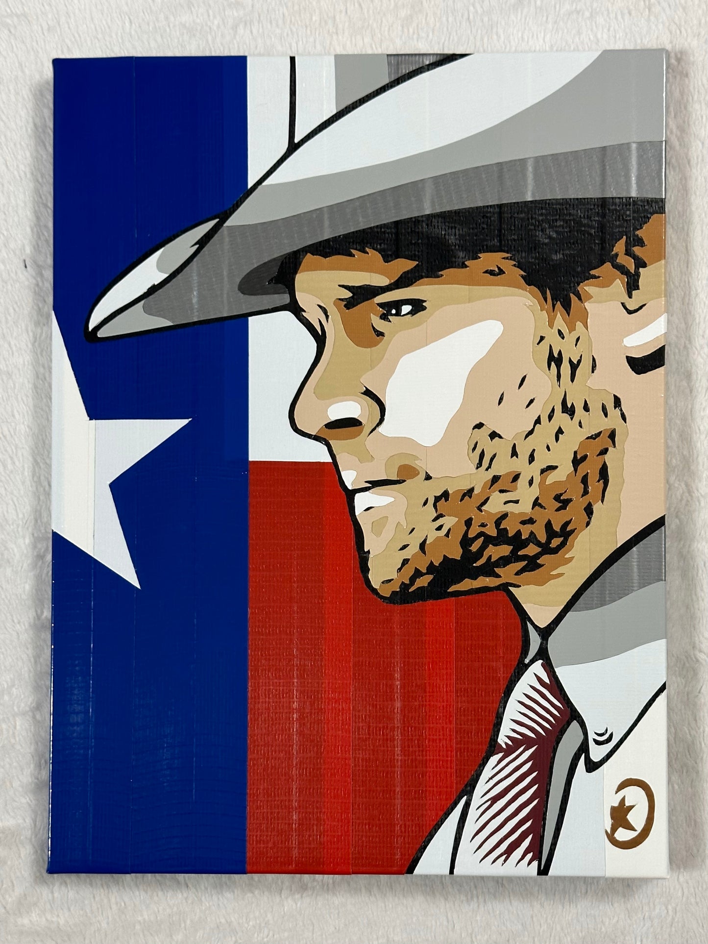 An image of Jared Padalecki as Walker from the TV series. Behind his face is the Texas flag. The image is created from colored duct tape.