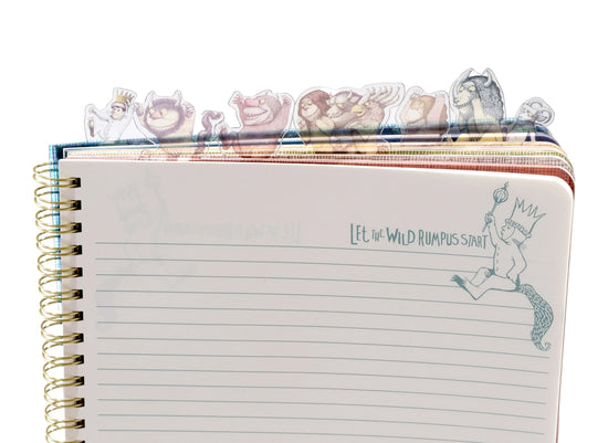 A page from the book with blank lines. In the top corner is a drawing of Max carrying a scepter. Green text says "let the wild rumpus start." At the top of the journal are tabs depicting characters from the book.