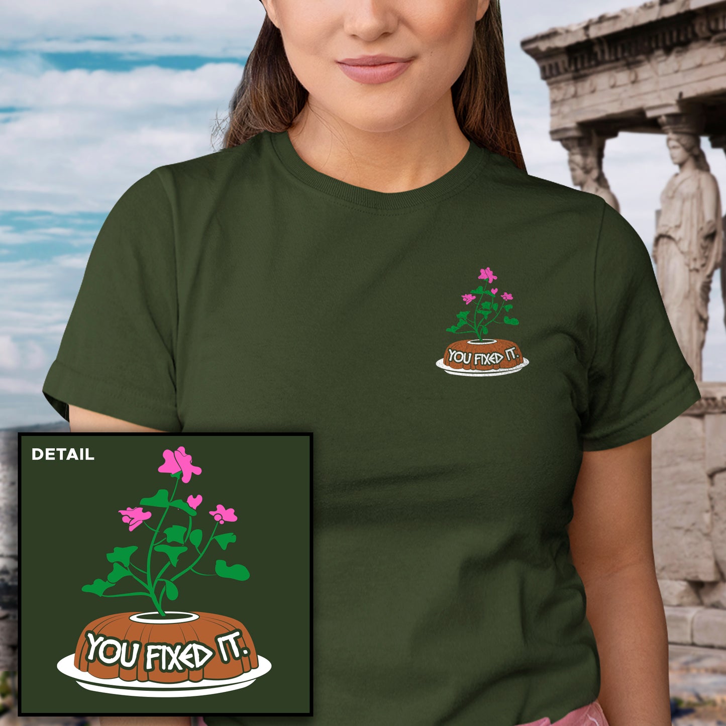 Person wearing a green t-shirt with a cake graphic and text 'YOU FIXED IT' in front of classical architecture.