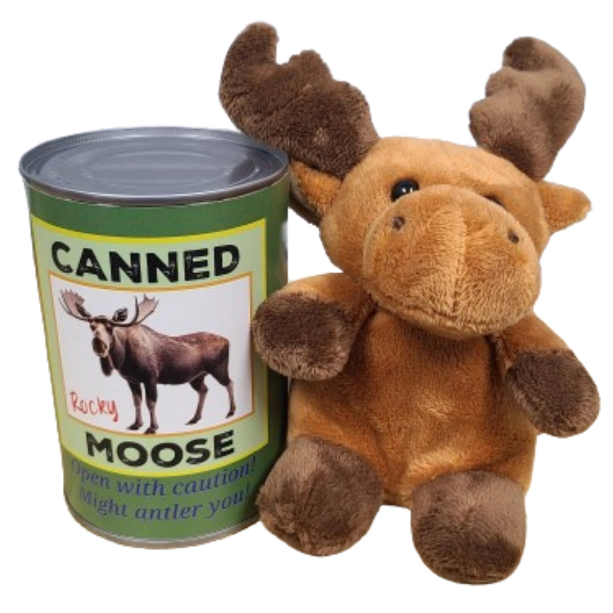 A moose plushie sitting next to a green can. The front of the can has a picture of a moose, with black and blue text that says "canned moose. Open with caution! Might antler you!"