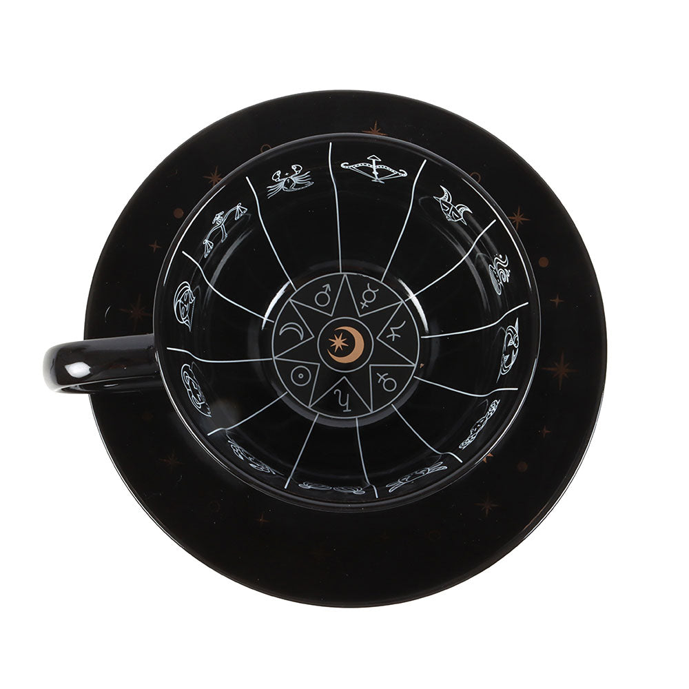 Black mug with astrological design on a white background