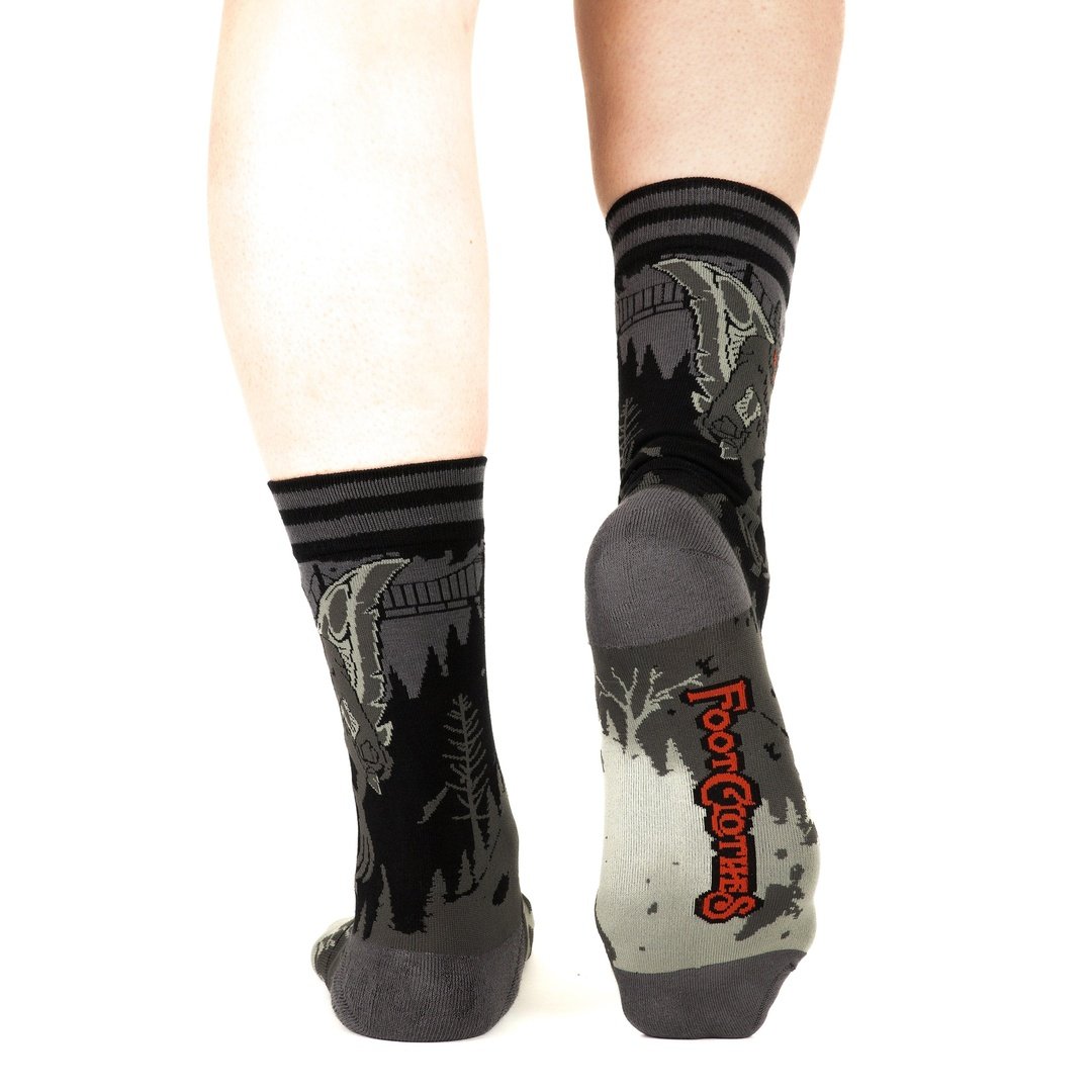 Gray socks with nature-themed design and brand logo on a white background