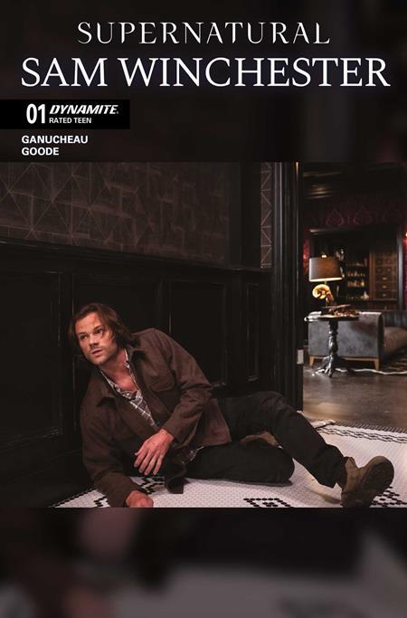 Comic book cover for 'Supernatural: Sam Winchester' issue 01 by Dynamite, featuring a seated man in a brown jacket and dark pants in a dim interior scene.