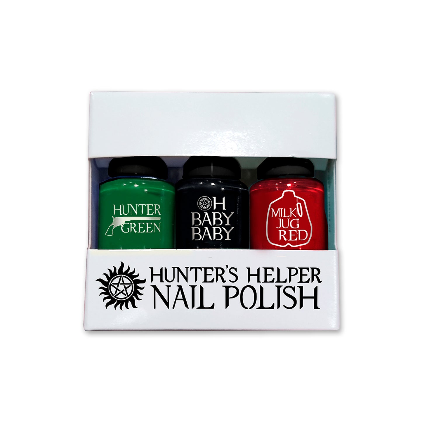 A white, windowed box with the words "Hunter's Helper Nail Polish" and an anti-possession symbol in black. There are 3 cylindrical bottles of nail polish in the box labeled "Good to be queen" (a magenta color), "Don't be an idjit" (olive green), and "Sheriff badge" (metallic gold). 