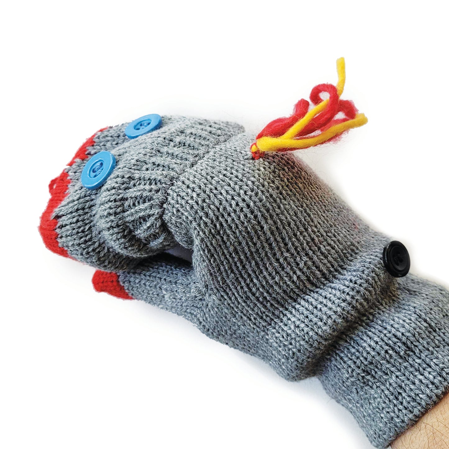 Rear view: A set of knit grey flip-top mittens, each with two blue button 'eyes' sewn onto the flip top. Red yarn forms a sock puppet 'mouth' at the top and there is red-and-yellow yarn 'hair' sewn below the knuckles. 