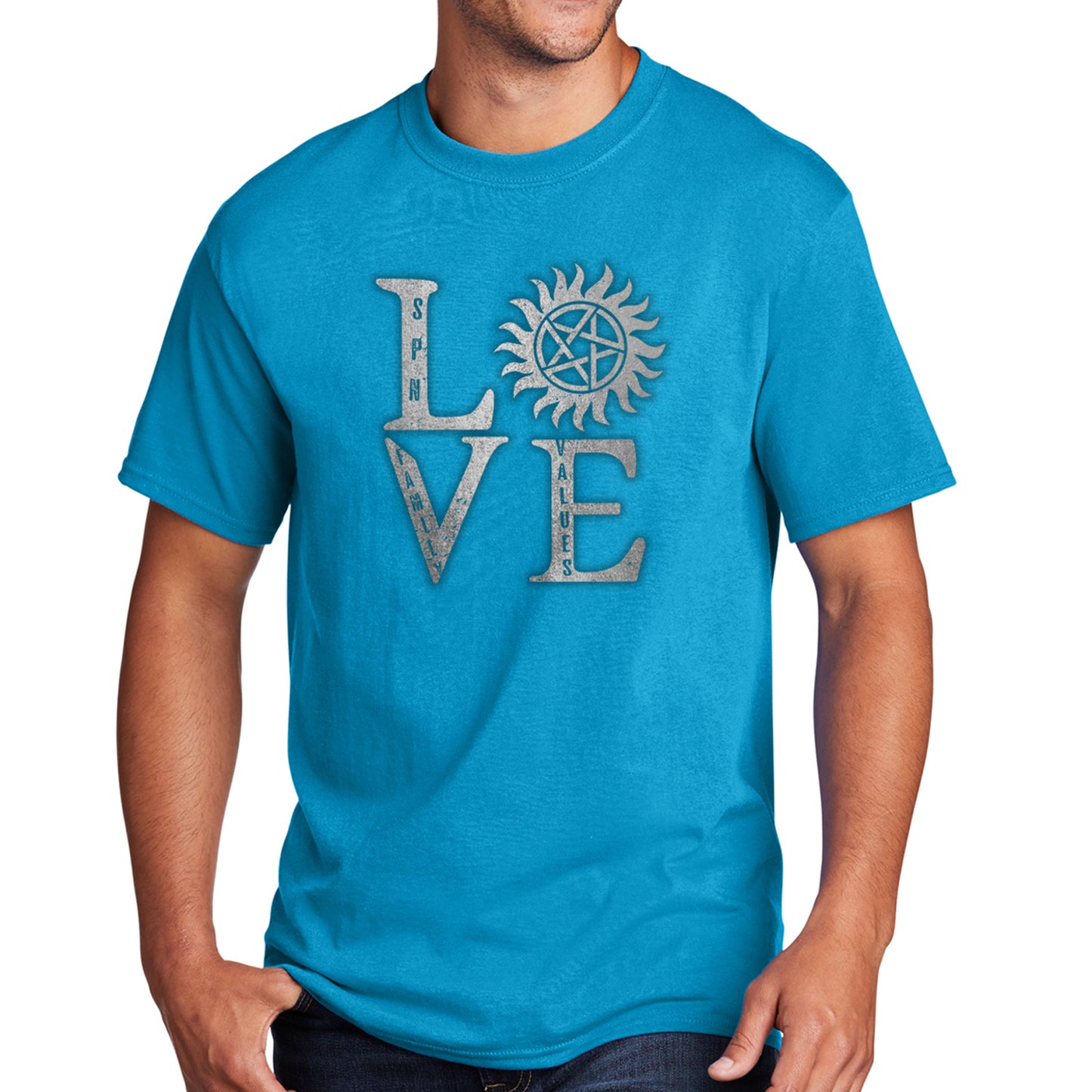 A male model wearing a turquoise t-shirt, against a white background. The front of the shirt has silver text saying "love," with the "O" replaced by the anti-possession symbol.
