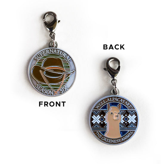 A brass charm with "Supernatural season six", a cowboy hat against a multicolor background on one side and "Well, alpacas are the greenest animal" with an alpaca over a blue, black and white patterned background on the other